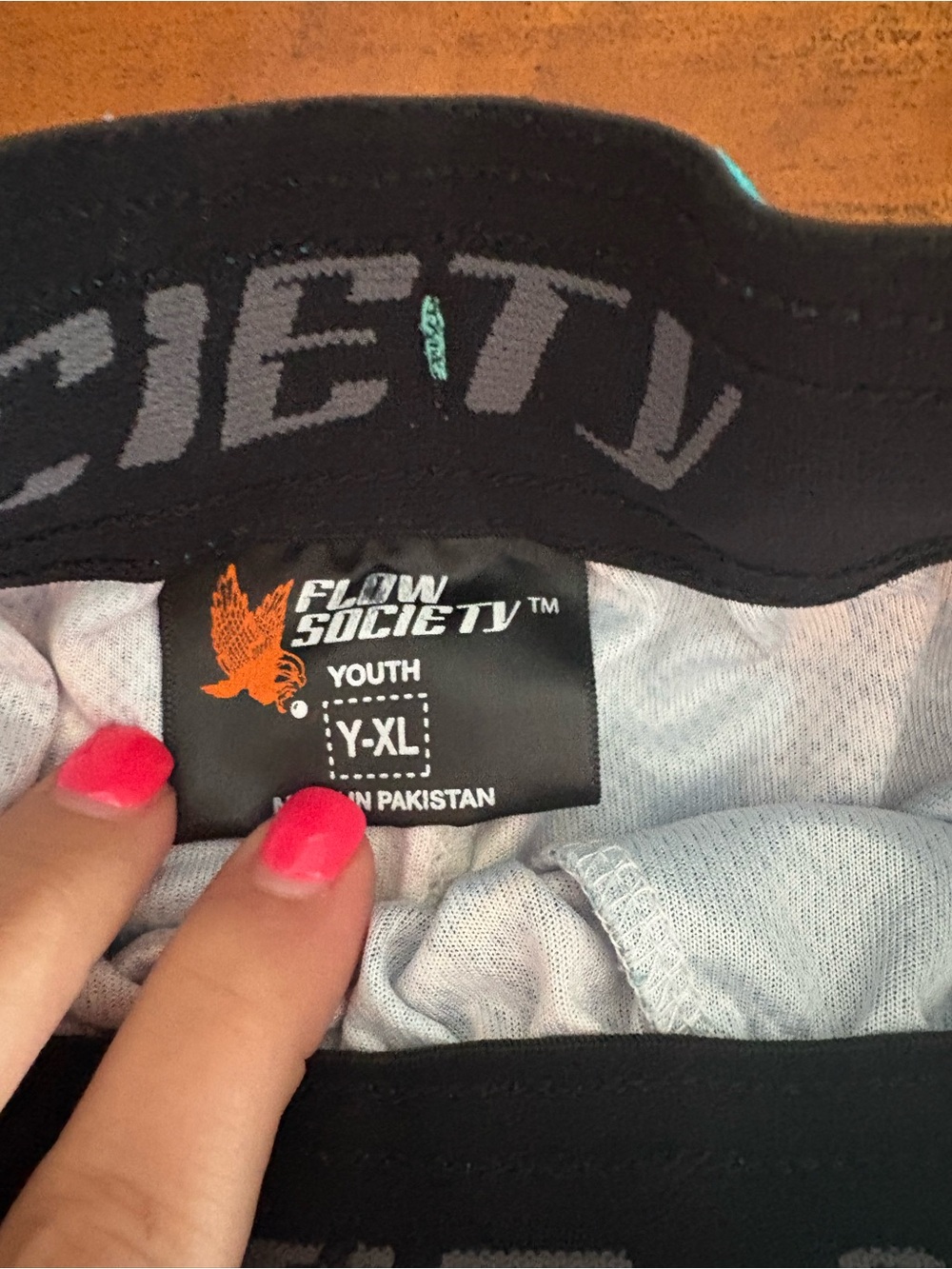 Flow Society Youth Black Graphic Waistband Top with Orange Logo